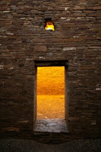 Threshold to the Ancients The doorway has stood here for a thousand years. On my side of the threshold, I am in deep shadow. There is nothing in these ruins but cold stone walls. But on the other side, a warm glow fills the air. I hear hints of whispers, as if the Ancient Ones are beckoning me. Where will this threshold take me? If I concentrate enough as I pass through, can it break the chains of time? I step forward.